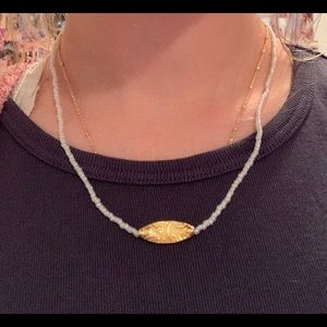 Electric beaded necklace with gold floral bead